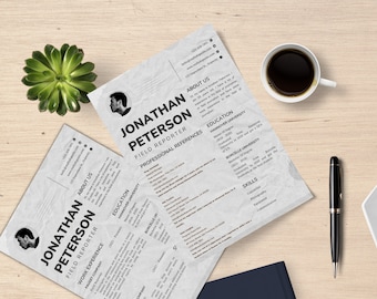 May include: Two resumes with the name "Jonathan Peterson, Field Reporter" are displayed on a wooden surface. A cup of coffee, a pen, and a succulent plant are also present. The resumes have a textured, crumpled paper appearance.