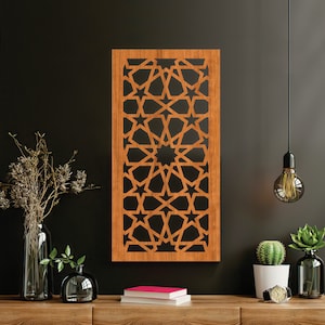 May include: A wooden wall decor with a geometric pattern of stars and intricate designs. The decor is brown and has a black background.