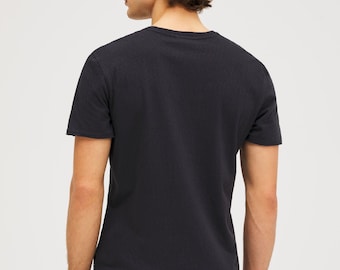 May include: A dark blue short-sleeved t-shirt with a crew neck.