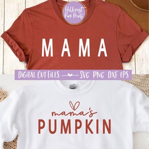 May include: Two white t-shirts with a red and white design. The first shirt says "MAMA" in white letters. The second shirt says "mama's PUMPKIN" in red letters with a small red heart above the word "mama's".