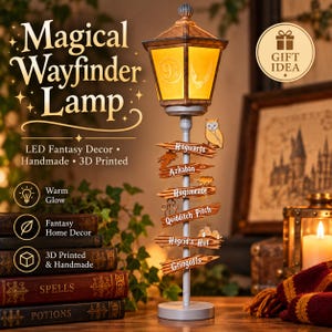 May include: A decorative lamp featuring a yellow lantern top with a 9 3/4 emblem and a central pole adorned with multiple wooden-style directional signs labelled Hogwarts, Azkaban, Hogsmeade, Quidditch Pitch, Hagrid's Hut, and Gringotts.
