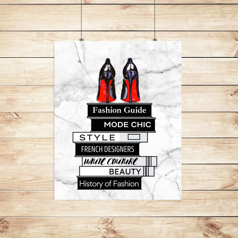 May include: A white marble background with a stack of books with black and white text. The books are titled "Fashion Guide", "Mode Chic", "Style", "French Designers", "Haute Couture", "Beauty", and "History of Fashion". Two black high-heeled shoes with red soles are on top of the books.