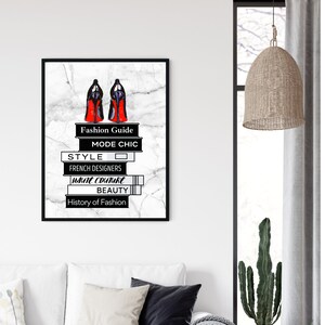 May include: Black and white illustration of a pair of red high heels on a stack of books with the words "Fashion Guide", "Mode Chic", "Style", "French Designers", "Haute Couture", "Beauty", and "History of Fashion" on the spines.