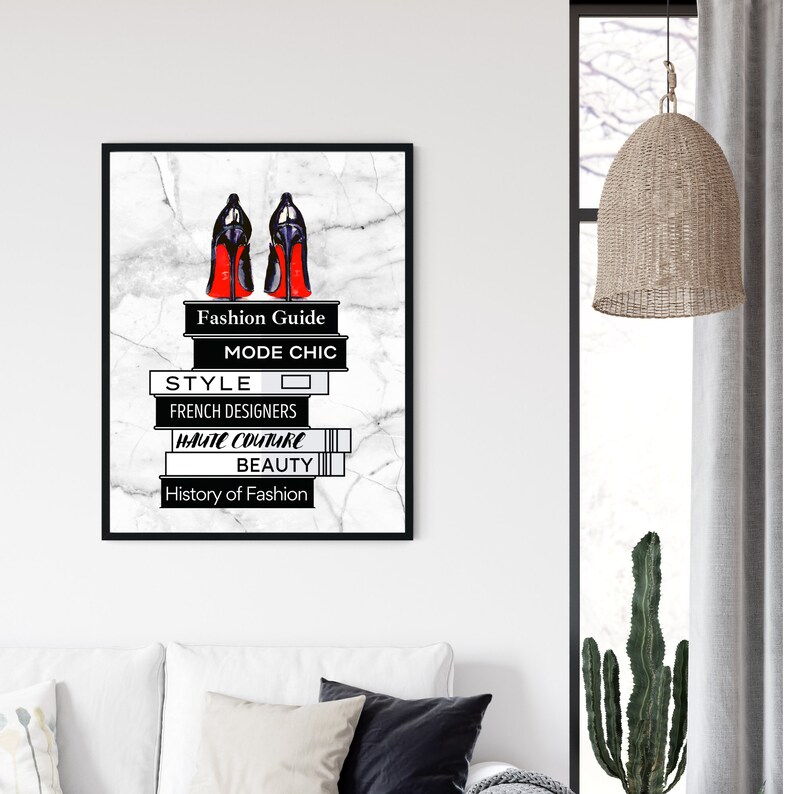 May include: Black and white illustration of a pair of red high heels on a stack of books with the words "Fashion Guide", "Mode Chic", "Style", "French Designers", "Haute Couture", "Beauty", and "History of Fashion" on the spines.