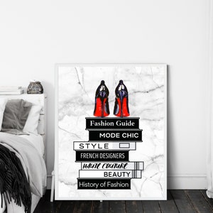 May include: A stack of books with black and white text on a white marble background. The books are titled "Fashion Guide", "Mode Chic", "Style", "French Designers", "Haute Couture", "Beauty", and "History of Fashion". A pair of red-soled black high heels are on top of the books.