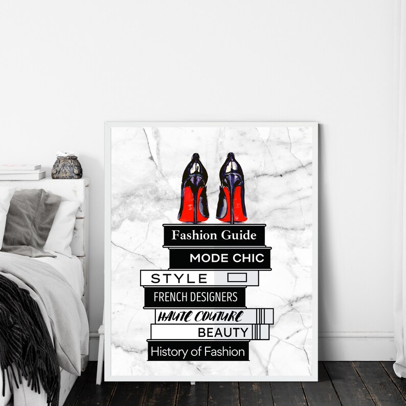 May include: A stack of books with black and white text on a white marble background. The books are titled "Fashion Guide", "Mode Chic", "Style", "French Designers", "Haute Couture", "Beauty", and "History of Fashion". A pair of red-soled black high heels are on top of the books.