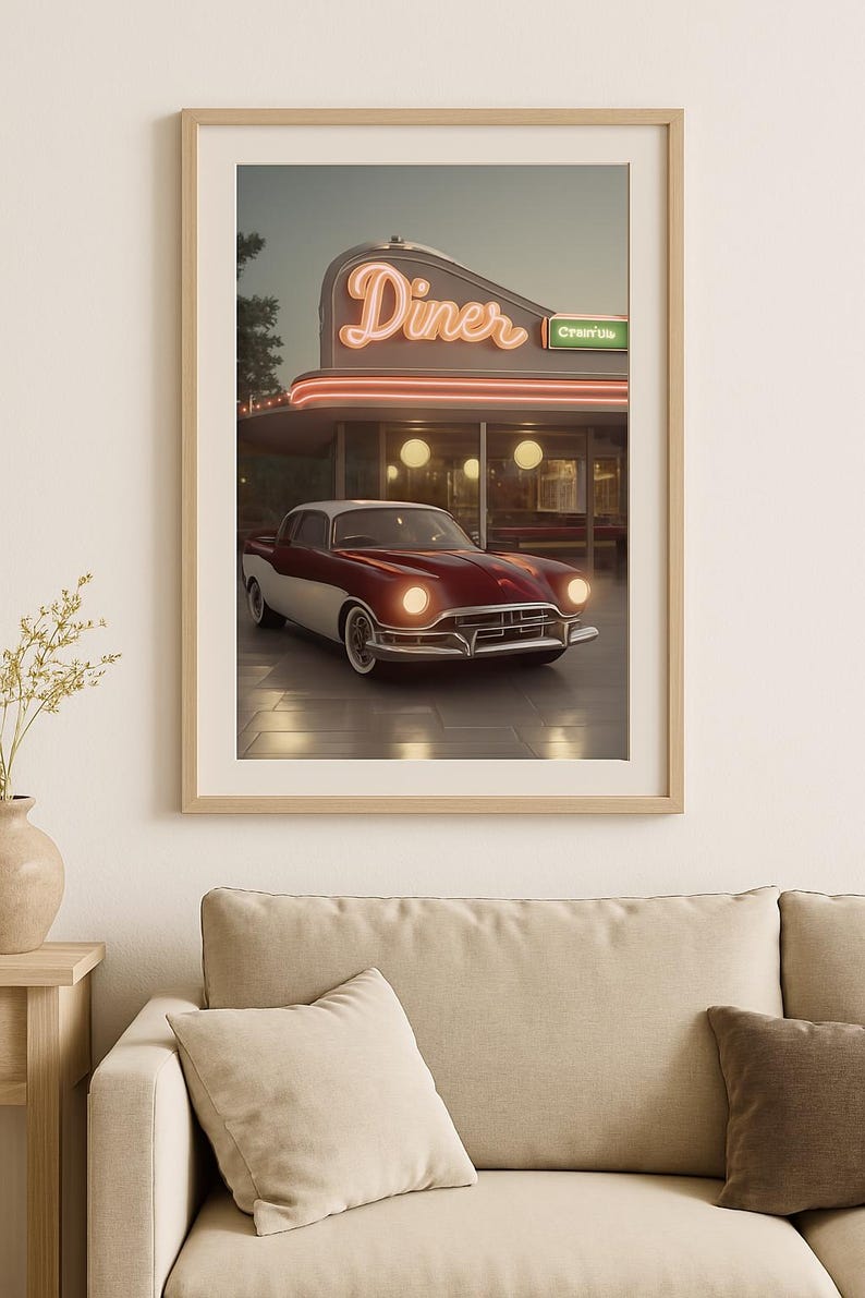 May include: A vintage red and white car parked in front of a retro diner with a neon sign that reads "Diner" and a green sign that reads "Creamy".