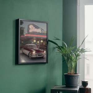 May include: A framed print of a vintage red and white car parked in front of a diner with a neon sign that reads "Diner".