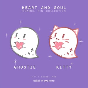 May include: Two enamel pins, approximately 1 inch in size, featuring a ghost and a cat holding pink glitter hearts. The ghost pin is silver and the cat pin is rose gold. The text "HEART AND SOUL ENAMEL PIN COLLECTION" is at the top of the image. The text "GHOSTIE" is below the ghost pin and the text "KITTY" is below the cat pin. The text "~1" ENAMEL PINS seiki @ oyakoro" is at the bottom of the image.