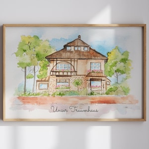 Peut inclure: Peinture à l'aquarelle d'une maison avec un toit marron, des murs beiges et des arbres verts. L'œuvre est encadrée dans un cadre en bois brun clair. Le texte "Unser Traumhaus" est écrit en cursive en bas.