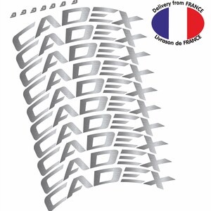 May include: Silver sticker with the word "CADEX" repeated multiple times in a curved design.