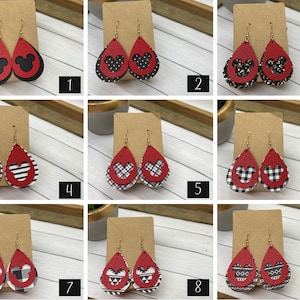 May include: Nine pairs of red and black dangle earrings with a Mickey Mouse silhouette cutout. Each pair features a different pattern on the back of the earring.