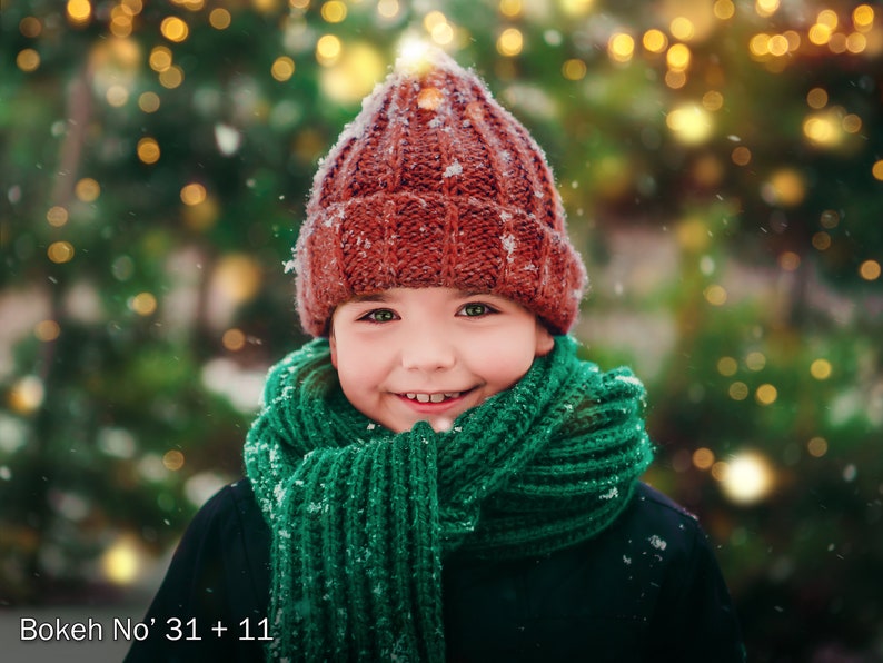 May include: A rust-colored knit beanie with a ribbed texture and a thick, vibrant green knit scarf. The beanie and scarf are dusted with light snowflakes. The text "Bokeh No' 31 + 11" is printed in the bottom left corner of the image.