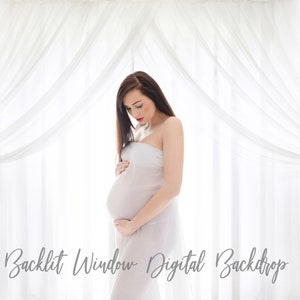 May include: A pregnant woman stands in front of a white sheer curtain backdrop. The curtains are draped in a way that creates a soft, ethereal look. The woman is wearing a white sheer dress and is holding her belly.