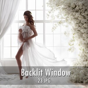 May include: A sheer white maternity gown with a ruffled bodice and a long, flowing skirt. The garment is worn in front of a large window with white curtains and a vertical arrangement of white flowers. The text Backlit Window 23 JPG is visible.