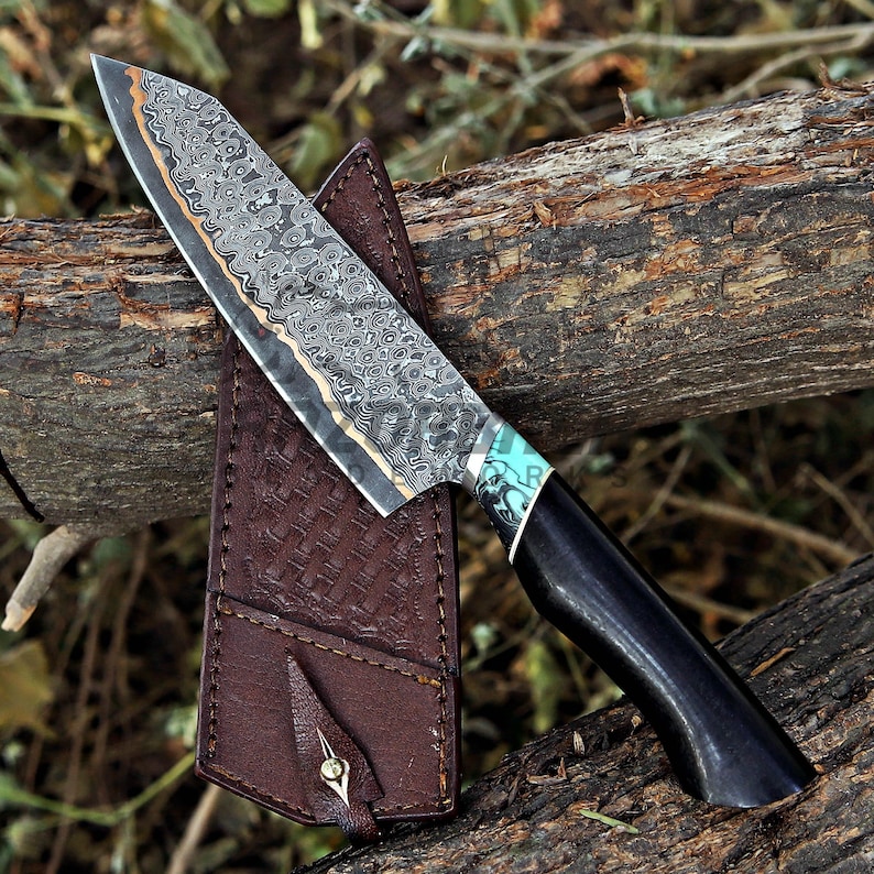 May include: A fixed-blade knife featuring a patterned Damascus steel blade with a copper-colored spine, a black handle with a turquoise inlay, and a brown leather sheath with a woven texture and a single metal stud fastener.