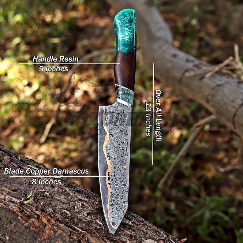 May include: A knife with a copper Damascus steel blade measuring 8 inches, a handle made of wood and teal resin measuring 5 inches, and an overall length of 13 inches. The blade features a distinct wavy pattern and a copper-colored edge.