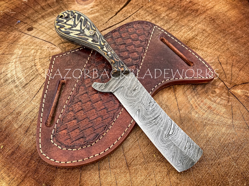 Damascus bull cutter knife with pancake sheath, the handle has forging marks on the handle, the knife is 8" overall which makes it easier to carry for the cowboys. this one is a perfect outdoor knife for cowboys