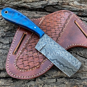 damascus blue cutter knife with blue resin handle and ladder style pattern blade, the sheath is a real leather pancake sheath with weave pattern on it, the knife is hand forged cowboy knife