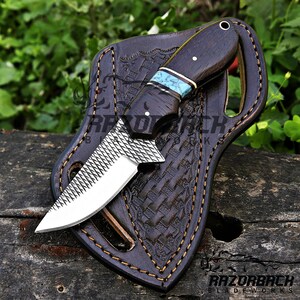 farrier rasp skinner knife with wenge wood handle and black leather sheath, the blade has a drop point shape and farrier rasp blade, the knife has a lanyard hole in the handle, the sheath is a pancake styled weave sheath