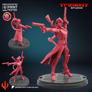 May include: A red 3D-printed figurine of a female character in a dynamic pose, holding multiple firearms. The figure is wearing a long coat and tactical gear, standing on a circular base. The Trident Studio logo is visible.