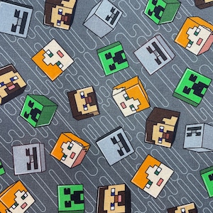 May include: A gray fabric with a repeating pattern of Minecraft characters. The characters include Steve, Alex, and the Creeper. The characters are in a pixelated style.