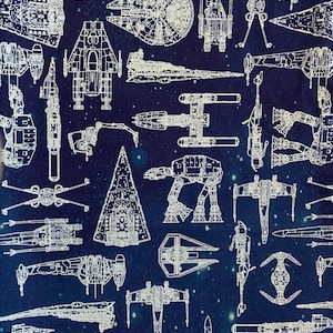 May include: A blue background with white outlines of various spaceships, including the Millennium Falcon, X-Wings, TIE fighters, and AT-ATs.