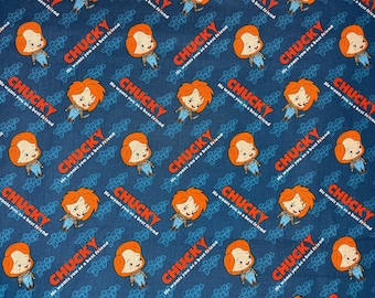 May include: Blue fabric with a repeating pattern of a red-haired doll with a knife, holding a knife, and the text "Chucky He wants you as a best friend".