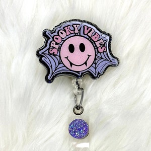 Interchangeable or permanent glitter spooky vibes badge reel