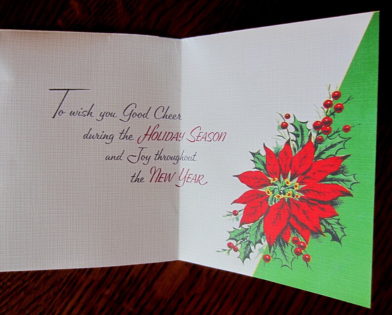 May include: A vintage Christmas card with a red poinsettia and green holly leaves on a green background. The card reads "To wish you Good Cheer during the HOLIDAY SEASON and Joy throughout the NEW YEAR."
