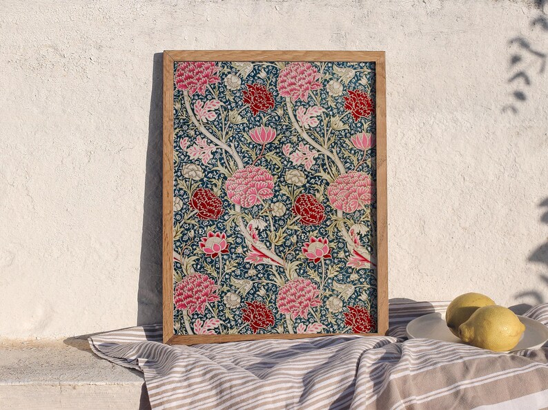 May include: A framed print of a floral pattern with pink, red, and white flowers on a dark blue background.