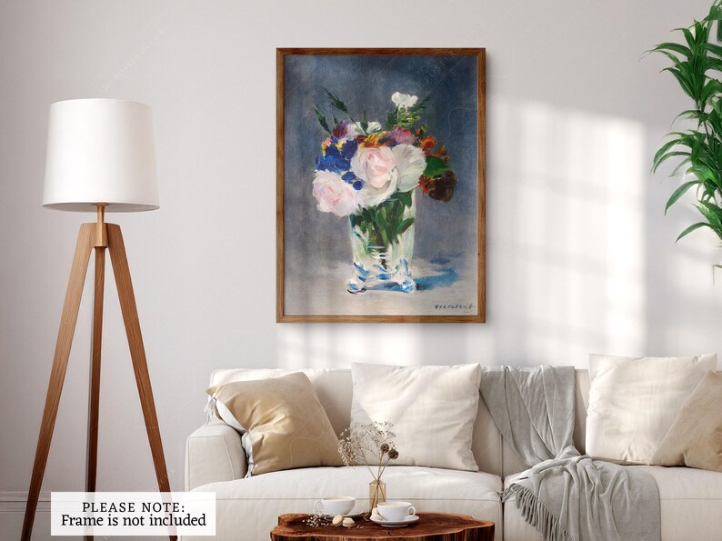May include: A painting of a bouquet of white, pink, and blue flowers in a clear glass vase. The flowers are arranged in a loose, natural style, and the vase is decorated with a delicate pattern. The background is a soft blue.
