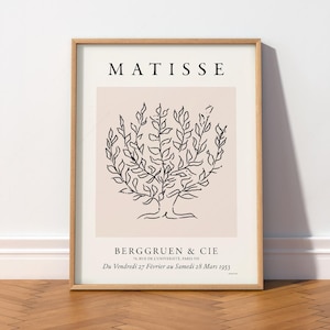 May include: A framed art print featuring a black line drawing of a tree on a light pink background. The text MATISSE appears at the top, with BERGGRUEN & CIE, 70, RUE DE L'UNIVERSITE, PARIS-VII, and Du Vendredi 27 Février au Samedi 28 Mars 1953 below.