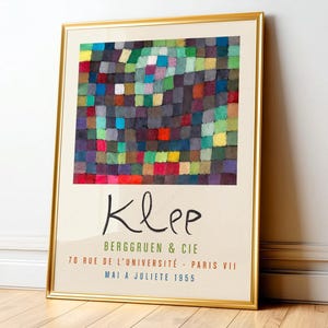 Modern abstract art featuring a vibrant mosaic of interlocking squares in rich hues of green, red, blue, and yellow, creating a dynamic interplay of color and texture. The composition evokes a sense of rhythm and movement, with soft edges blending into one another, while structured forms add depth and intrigue. The piece embodies a playful yet contemplative mood, inviting viewers to explore its intricate layers. Paul Klee framed and displayed on a living room wall.
