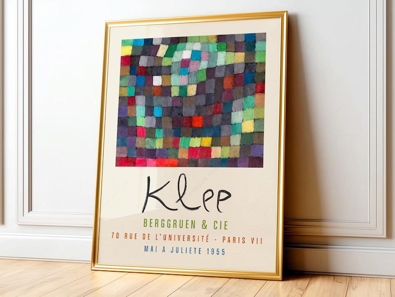 Modern abstract art featuring a vibrant mosaic of interlocking squares in rich hues of green, red, blue, and yellow, creating a dynamic interplay of color and texture. The composition evokes a sense of rhythm and movement, with soft edges blending into one another, while structured forms add depth and intrigue. The piece embodies a playful yet contemplative mood, inviting viewers to explore its intricate layers. Paul Klee framed and displayed on a living room wall.