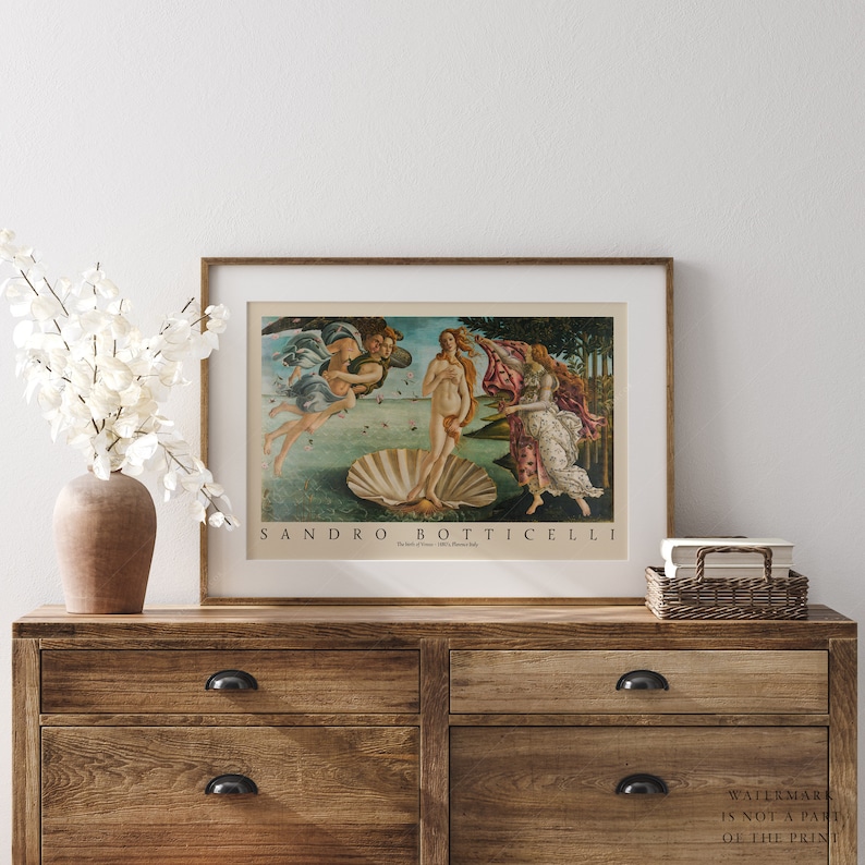 May include: A framed print of Sandro Botticelli's The Birth of Venus, a famous Renaissance painting depicting the goddess Venus emerging from a giant scallop shell. The painting is set against a backdrop of a blue sky and a green landscape.