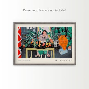 May include: A print of Henri Matisse's 1940 painting Int&eacute;rieur au vase &eacute;trusque, featuring a person at a table with a large orange vase, green plants, and fruit. The text reads Please note: Frame is not included, Int&eacute;rieur au vase &eacute;trusque, 1940, H. MATISSE.