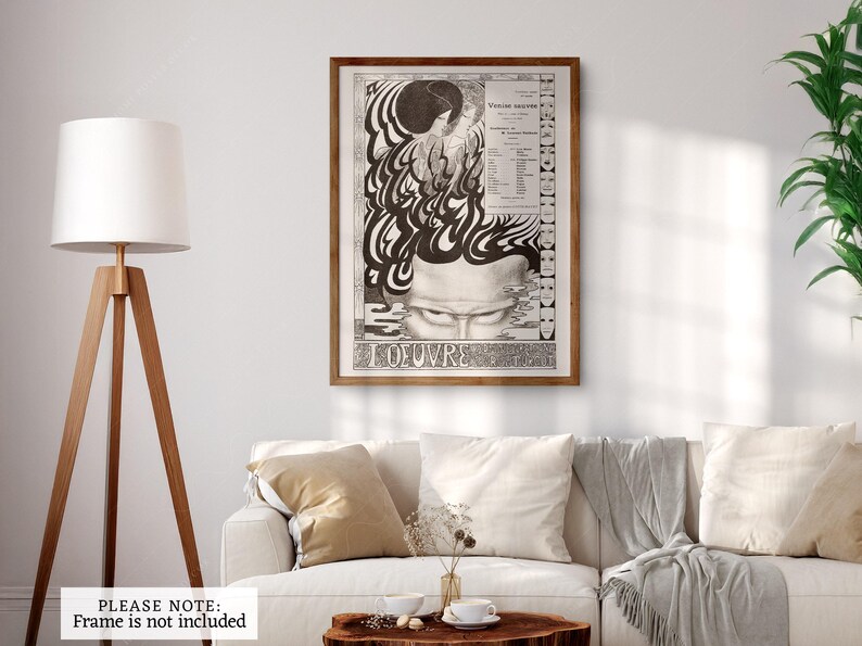 May include: A black and white poster with a psychedelic design featuring a face with closed eyes and the text "L'OEUVRE" at the bottom. The poster is framed in a brown wood frame.