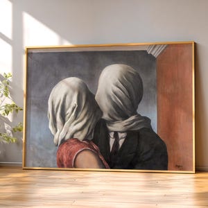 May include: A framed wall art print depicting two figures with their heads completely covered by white fabric. One figure wears a red garment, while the other wears a dark suit with a tie. The background features a grey wall and a vertical orange panel.