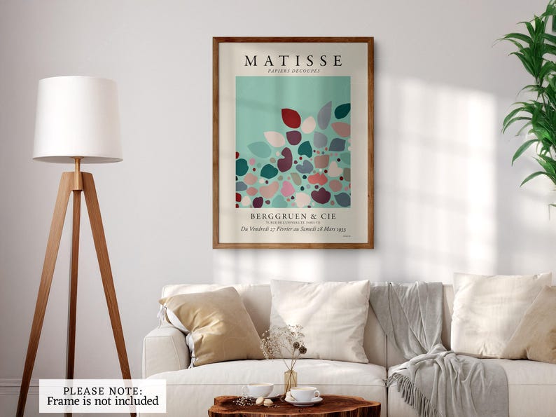 May include: A vintage poster for an art exhibition featuring a colorful abstract design of cut paper shapes in shades of pink, red, green, and blue on a light blue background. The poster is titled "Matisse, Papiers Decoupes" and includes the text "Berggruen & Cie (Du Vendredi 17 Fevrier au Samedi 11 Mars 1955)".