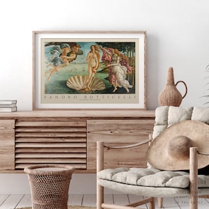 May include: A vintage-style print of Sandro Botticelli's The Birth of Venus, featuring a nude woman standing on a giant seashell, with two figures in the background. The print has a wooden frame and a white background.