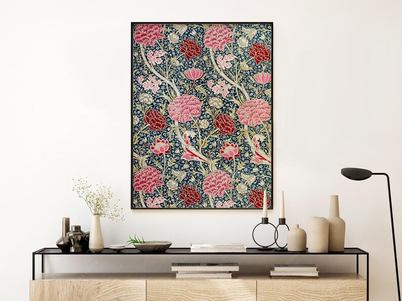 May include: A framed print of a vintage floral pattern featuring pink and red flowers on a dark blue background. The flowers are stylised and have a repeating pattern.