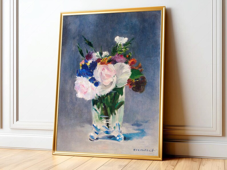 Impressionist floral still life featuring vibrant bouquet of soft pink peonies, deep blue irises, and bright orange marigolds arranged in clear glass vase, set against moody, textured slate-blue background. The brush strokes are loose and dynamic, creating sense of movement and life within the composition. The light reflects delicately off the vase, enhancing the freshness of the flowers. 'Bouquet' by Edouard Manet framed and displayed on living room wall. Printed poster wall art.