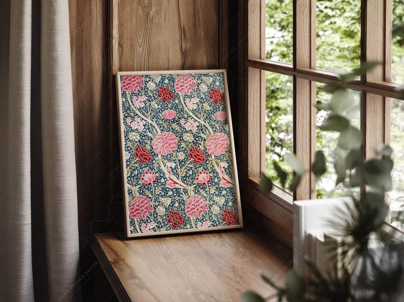 May include: A framed print with a floral pattern featuring pink and red flowers on a dark blue background.