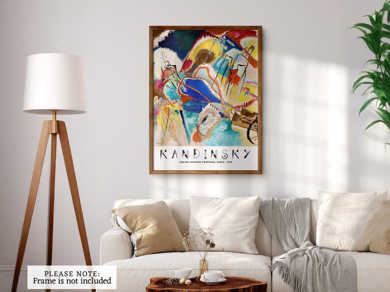 May include: Abstract art print featuring a colorful painting by Wassily Kandinsky titled "Improvisation 28 (Second Version)". The print is framed in a brown wood frame and includes the artist's name and title of the artwork.