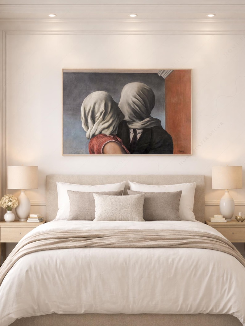 May include: A rectangular wall art print featuring a reproduction of The Lovers by Rene Magritte. The painting depicts two figures with their heads covered in white fabric, one wearing a red top and the other a dark suit, set against a blue and red wall.