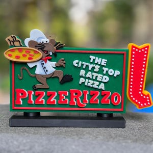 May include: A colorful sign for Pizzerizzo, featuring a cartoon chef rat holding a pizza. The sign is green with red and white text that reads "The City's Top Rated Pizza" and "Pizzerizzo". A red arrow with white lights is on the right.