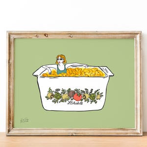 May include: Illustration of a woman in sunglasses relaxing in a box filled with golden chips. The box is white with a floral and fruit design and the text "L'échalote". The artwork is framed and set against a light green background.