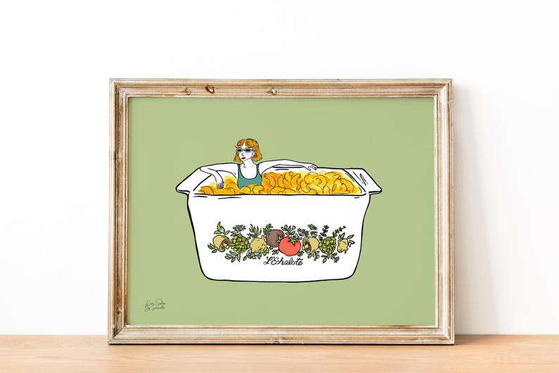 May include: A framed art print featuring a woman in sunglasses relaxing in a box filled with golden chips. The box is white with a decorative floral and fruit design and the text "L'&eacute;chalote". The background is a light green.
