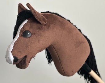 May include: Brown and white plush horse head with black mane and tail, used for riding.